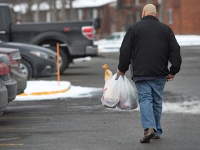 Shopper carries plastic grocery bags full of groceries at the Metro store in Notre-Dame-de l'Ile-Perrot on Saturday January 30, 2016. (Marie-France Coallier / MONTREAL GAZETTE)