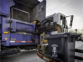A garbage bin is picked up by a Services Matrec  truck in Beaconsfield on Thursday, Jan. 7, 2016.