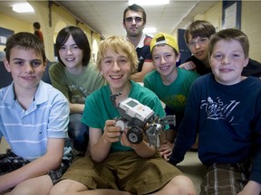 Science teacher Doug Cadot (back) with students from the robotics program at John Rennie High School Friday, June 12, 2009.  (THE GAZETTE/John Kenney)