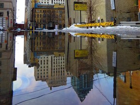 Reflections of the city are seen on an unusually warm winter day.