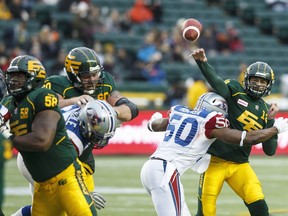 Alouettes linebacker Henoc Muamba brings down Eskimos quarterback Mike Reilly at Commonwealth Stadium in Edmonton on Nov. 1, 2015.