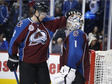Colorado Avalanche defenceman Nick Holden, left, congratulates goalie Semyon Varlamov as time runs out in the third period of an NHL hockey game against the Montreal Canadiens Wednesday, Feb. 17, 2016, in Denver. Colorado won 3-2.
