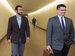 Omar Khadr, left, leaves court with his lawyer Nate Whitling, right, after a judge ruled to relax bail conditions in Edmonton on Sept. 18, 2015. The federal government has decided against pursuing an appeal of an Alberta court's decision to grant former Guantanamo Bay inmate Omar Khadr bail.