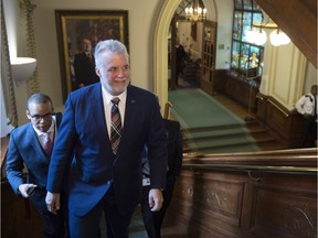 Quebec Premier Philippe Couillard walks to a pre-session caucus Thursday, February 4, 2016 at the legislature in Quebec City.