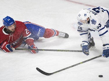 Montreal Canadiens' Phillip Danault (24) collides with Toronto Maple Leafs' Mark Arcobello (33) during second period NHL hockey action in Montreal, Saturday, February 27, 2016.
