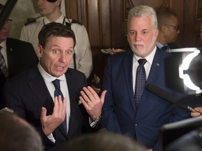 Quebec Education Minister Pierre Moreau (left) nwith Quebec Premier Philippe Couillard, Feb. 16, 2016, at the legislature in Quebec City.