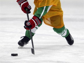 Ryder Flynn, of the Peace River Riders, tries to corral the puck during the Pomeroy Initiation Mega Tournament  on Saturday February 13, 2016 at the Coca-Cola Centre in Grande Prairie, Alta. The tournament, one of the largest in northern Alberta, featured 40 teams that played on Feb. 12-14 at the arena. No scores were kept. Two games were played on the ice at one time with each game being played on one half of the ice. Dividers were set up across the centre. Logan Clow/Grande Prairie Daily Herald-Tribune/Postmedia Network