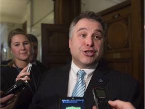 Quebec's new Education Minister Sébastien Proulx responds to reporters questions as he walks out of a party caucus meeting, Tuesday, Feb. 23, 2016 at the legislature in Quebec City.