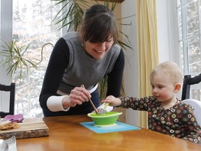 Marianne McEwen serves homemade carrot soup to her 17-month-old daughter Solena at their home in Magog.
