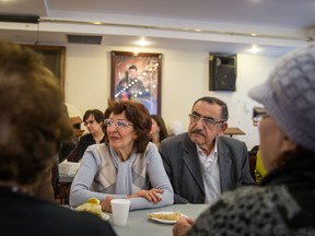A retired couple who arrived from Syria on December 29, 2015, Sara Weratheh, left, who was an English teacher, and her husband Said Bahhady, right, who was a lawyer, listen to a conversation during an event to break the fast for the celebration of the story of Jonah and the whale held at the St-Jacques Syriac Orthodox Church in Montreal on Wednesday, Feb. 24, 2016. Weratheh and her husband were privately sponsored to come to Canada by her brother's son, who is a pharmacist.