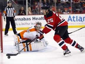 Devils centre Stefan Matteau attacks Flyers goalie Michal Neuvirth during the second period on Friday, Dec. 4, 2015, in Newark, N.J. The Canadiens traded Devante Smith-Pelly to the New Jersey Devils for Matteau on trade deadline day.