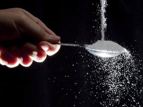 Sugar is poured on a tablespoon in a photo illustration in North Vancouver, B.C. Wednesday, Sept. 21, 2011.