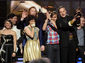 Win Butler (right), Regine Chassagne and the band Arcade Fire accept Album of the Year award for The Suburbs on Feb. 13, 2011 at The 53rd Annual Grammy awards.
