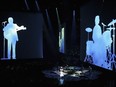 Projected images of the Beatles were seen during a preview of Love at the Mirage in Las Vegas in June 2006. The revamped show will include more sound bites and video of the band members, says director Dominic Champagne.