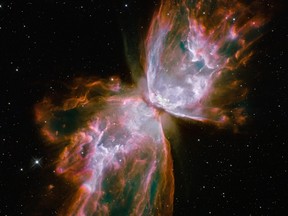 This image made by the NASA/ESA Hubble Space Telescope shows jets of gas heated to nearly 20,000 degrees Celsius traveling at more than 950,000 kilometres (59,000 miles) per hour streaming from they dying star NGC 6302, the "Butterfly Nebula" in the Milky Way galaxy.