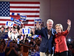 Democratic presidential candidate Hillary Clinton and husband Bill Clinton wave to a cheering crowd after winning the Nevada democratic caucus at Caesar's Palace in Las Vegas, Nevada on February 20, 2016.
