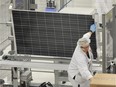 Staff work to assemble solar panels at the Celestica Green Technology Centre of Excellence in Toronto, June 16, 2011.