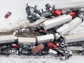 Vehicles pile up at the site of a fatal crash near Fredericksburg, Pa., Saturday, Feb. 13, 2016. The pileup left tractor-trailers, box trucks and cars tangled together across several lanes of traffic and into the snow-covered median.