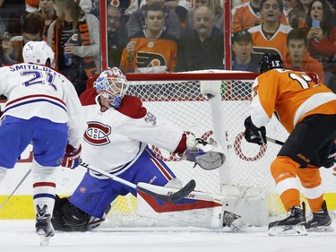 Philadelphia Flyers' Wayne Simmonds, right, scores a goal past Montreal Canadiens' Mike Condon, center, as Devante Smith-Pelly looks on during the first period of an NHL hockey game, Tuesday, Feb. 2, 2016, in Philadelphia.