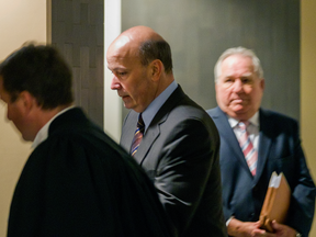 Former Montreal executive-committee chairman Frank Zampino, centre, and former Union Montreal financial chief  Bernard Trépanier, right, enter a courtroom at the Montreal courthouse on March 22, 2016, for the Contrecoeur corruption trial.