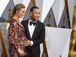 Christine Teigen, left, and John Legend arrive at the Oscars on Sunday, Feb. 28, 2016, at the Dolby Theatre in Los Angeles. THE CANADIAN PRESS/AP/Photo by Dan Steinberg/Invision/AP