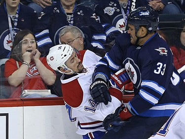 A fan reacts as Winnipeg Jets defenceman Dustin Byfuglien (right) hits Montreal Canadiens centre Tomas Plekanec in Winnipeg on Sat., March 5, 2016.