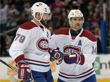 Montreal Canadiens' Andrei Markov (79), of Russia, celebrates with Tomas Plekanec (14), of the Czech Republic, after Markov scored during the second period of an NHL hockey game against the Buffalo Sabres, Wednesday, March 16, 2016, in Buffalo, N.Y.