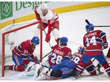 Detroit Red Wings' Anthony Mantha (39) scores against Montreal Canadiens goaltender Mike Condon as Canadiens' Phillip Danault (24), Nathan Beaulieu (28) and Tomas Plekanec (14) defend during second period NHL hockey action in Montreal on Tuesday, March 29, 2016.