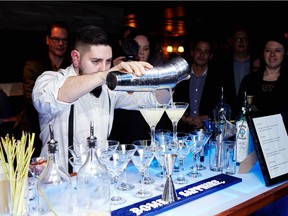 Bacardi mixologist Samuel Trudeau prepares martinis at the Blue Metropolis Foundation's Shaken, Not Stirred! fundraiser on Feb. 24.