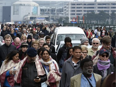 Passengers are evacuated from Brussels airport, on March 22, 2016 in Zaventem, after at least 13 people were killed and 35 injured as twin blasts rocked the main terminal of Brussels airport.