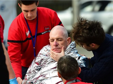 A victim receives first aid by rescuers, on March 22, 2016 near Maalbeek metro station in Brussels, after a blast at this station near the EU institutions caused deaths and injuries.