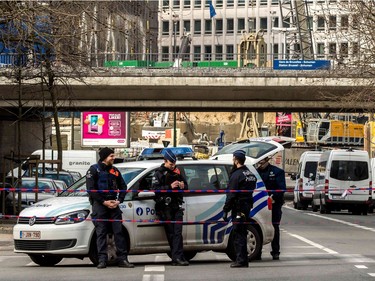 Belgian police block the access to streets near Maalbeek metro station in Brussels on March 22, 2016 after a series of apparently coordinated explosions ripped through Brussels airport and the metro train, killing at least 14 people in the airport and 20 people in the metro in the latest attacks to target Europe.