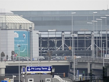 A picture shows damage to the facade of Brussels Airport, in Zaventem, on March 2016 after two explosions in the airport.  Belgian firefighters said there were at least 21 dead after "enormous" blasts hit Brussels airport and the city's metro system.