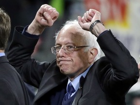 Democratic presidential candidate Sen. Bernie Sanders, I-Vt., pumps his fists as he leaves the field after speaking at a rally Friday, March 25, 2016, in Seattle.
