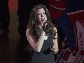 Brittany Kennell sings the U.S. and Canadian national anthem's prior to an NHL hockey game between the Montreal Canadiens and the New York Rangers in Montreal on Saturday, March 26, 2016.