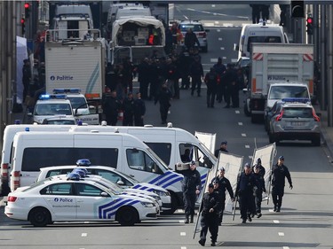 Soldiers, police officers and medical personnel attend the scene at the Maelbeek metro station following todays attack on March 22, 2016 in Brussels, Belgium.