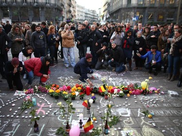 People leave tributes at the Place de la Bourse following today's attacks on March 22, 2016 in Brussels, Belgium.