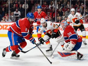 Canadiens' Greg Pateryn picks up a rebound left by goaltender Mike Condon during the NHL game against the Calgary Flames at the Bell Centre on March 20, 2016.