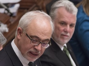 Quebec Finance Minister Carlos Leitao presents his budget speech, Thursday, March 17, 2016 at the Quebec Legislature. Quebec Premier Philippe Couillard, right, looks on.