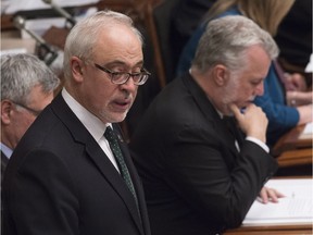 Quebec Finance Minister Carlos Leitao presents his budget speech, Thursday, March 17, 2016 at the Quebec Legislature. Quebec Premier Philippe Couillard, right, reads the budget documents.