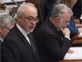 Quebec Finance Minister Carlos Leitao presents his budget speech, Thursday, March 17, 2016 at the Quebec Legislature. Quebec Premier Philippe Couillard, right, reads the budget documents.