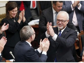 Quebec Finance Minister Carlos Leitao, centre, is applauded by members of the government before presenting a provincial budget, Thursday, March 26, 2015 at the legislature in Quebec City.