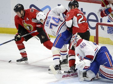 Ottawa Senators' Chris Neil (25) tries to settle a bouncing puck as teammate Curtis Lazar (27) and Montreal Canadiens' goalie Ben Scrivens (40) and Alexei Emelin (74) watch during second period NHL hockey action in Ottawa on Saturday, March 19, 2016.