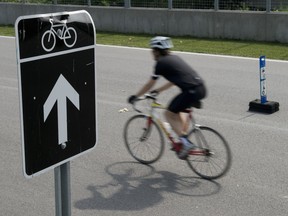 A cyclist rides on the course at Circuit Gilles-Villeneuve in Montreal on Wednesday, June 26, 2013.