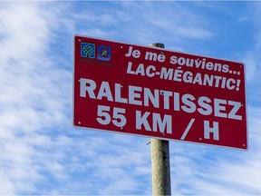 A sign on the CN train tracks saying "I remember Lac-Megantic, slow down" near the corner of Harwood boulevard and Robert avenue in Dorion on Saturday, March 12, 2016. (Dario Ayala / Montreal Gazette)