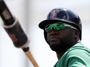 Boston Red Sox designated hitter David Ortiz, wearing green tinted glasses, warms up as he stands on deck in the first inning of a spring training baseball game against the Baltimore Orioles on Thursday, March 17, 2016, in Fort Myers, Fla. The team wore green themed uniforms in observance of St. Patrick's Day.