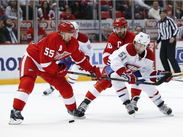 Detroit Red Wings defenseman Niklas Kronwall (55) and Detroit Red Wings left wing Henrik Zetterberg (40) defend Montreal Canadiens center David Desharnais (51) in the third period of an NHL hockey game, Thursday, March 24, 2016, in Detroit.
