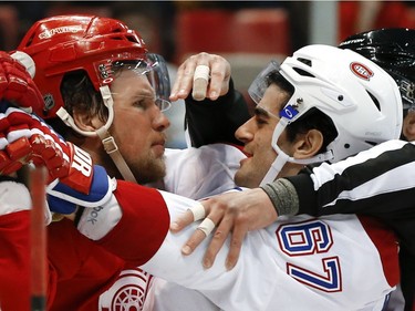 Detroit Red Wings left wing Justin Abdelkader (8) and Montreal Canadiens left wing Max Pacioretty (67) are separated by an official in the third period of an NHL hockey game, Thursday, March 24, 2016, in Detroit.