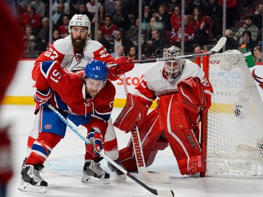 MONTREAL, QC - MARCH 29:  David Desharnais #51 of the Montreal Canadiens and Kyle Quincey #27 of the Detroit Red Wings battle for position in front of goaltender Jimmy Howard #35 during the NHL game at the Bell Centre on March 29, 2016 in Montreal, Quebec, Canada.