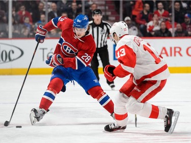 MONTREAL, QC - MARCH 29:  Nathan Beaulieu #28 of the Montreal Canadiens skates the puck against Pavel Datsyuk #13 of the Detroit Red Wings during the NHL game at the Bell Centre on March 29, 2016 in Montreal, Quebec, Canada.